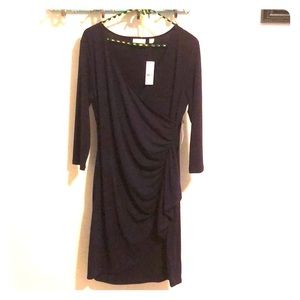 Dark purple, falls to the knee, dress.